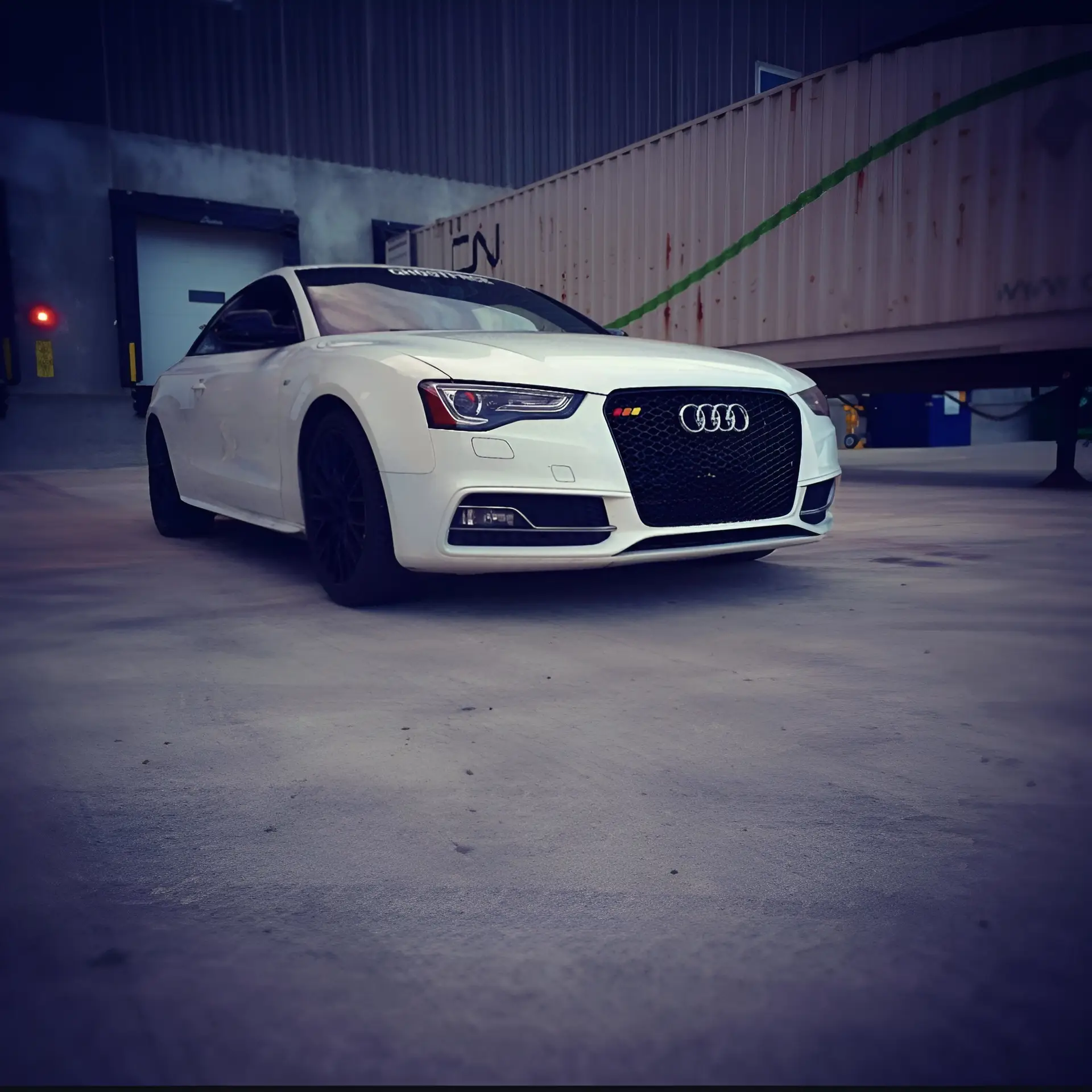 Audi S5 parked at some loading docks